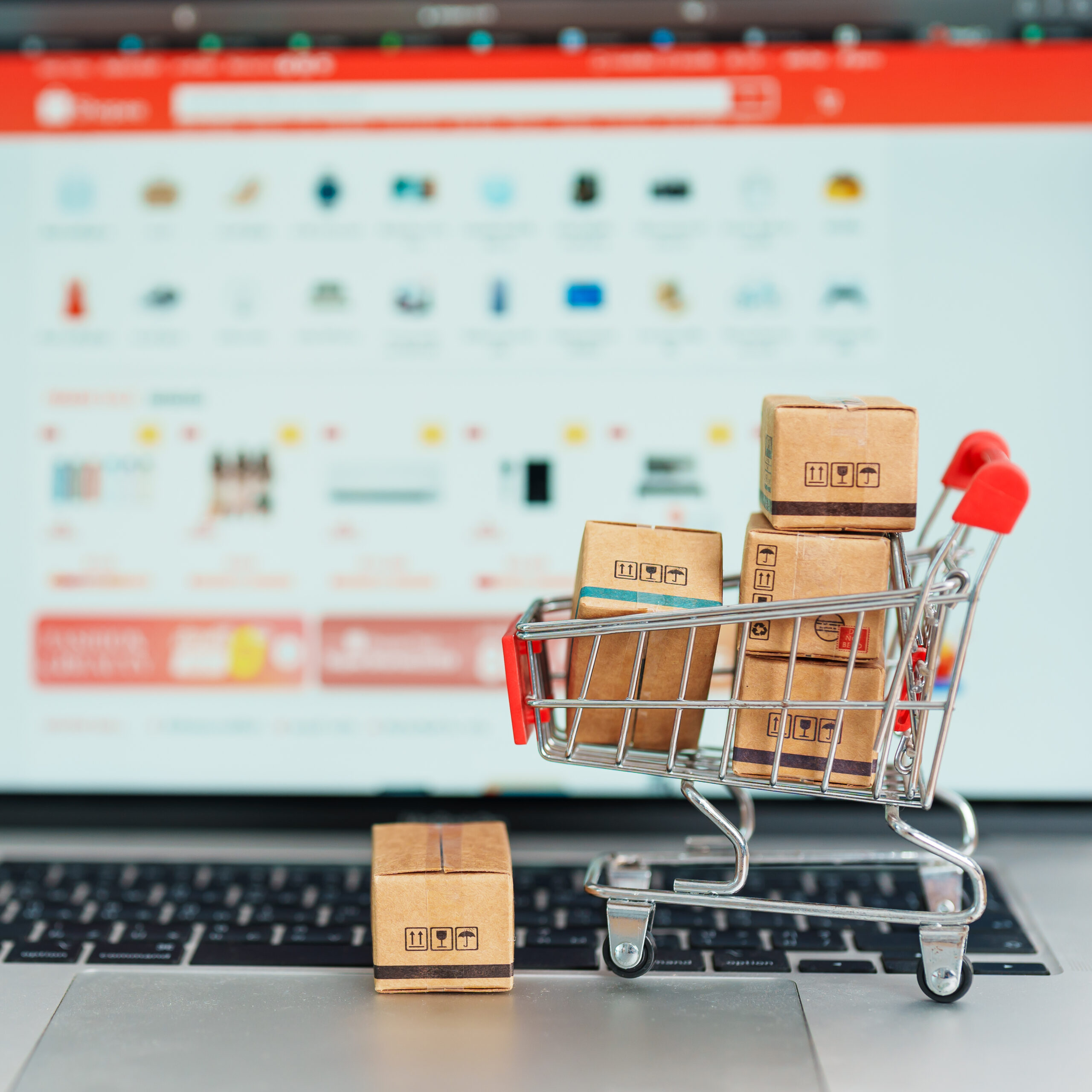 Boxes with shopping cart on a laptop computer. online shopping,